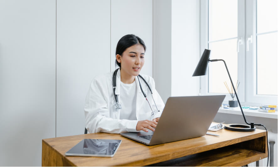 Healthcare Virtual Assistant working with a laptop in a office